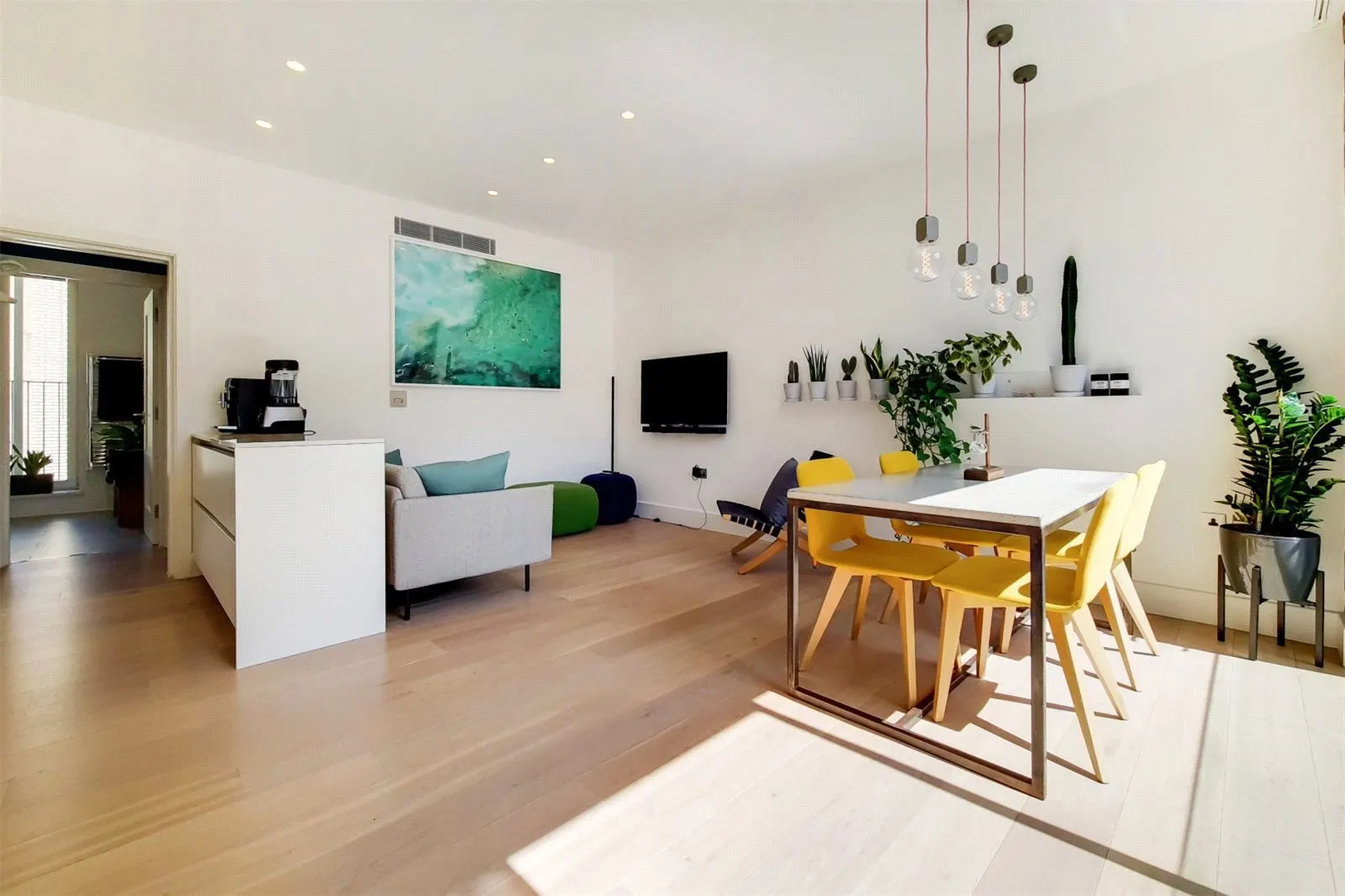 Open-plan living and dining room with oak floors and yellow dining chairs, 12-13 Richmond Buildings, Soho